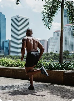 Man stretching outdoors with city skyline