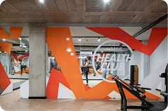 Modern gym with orange wall art